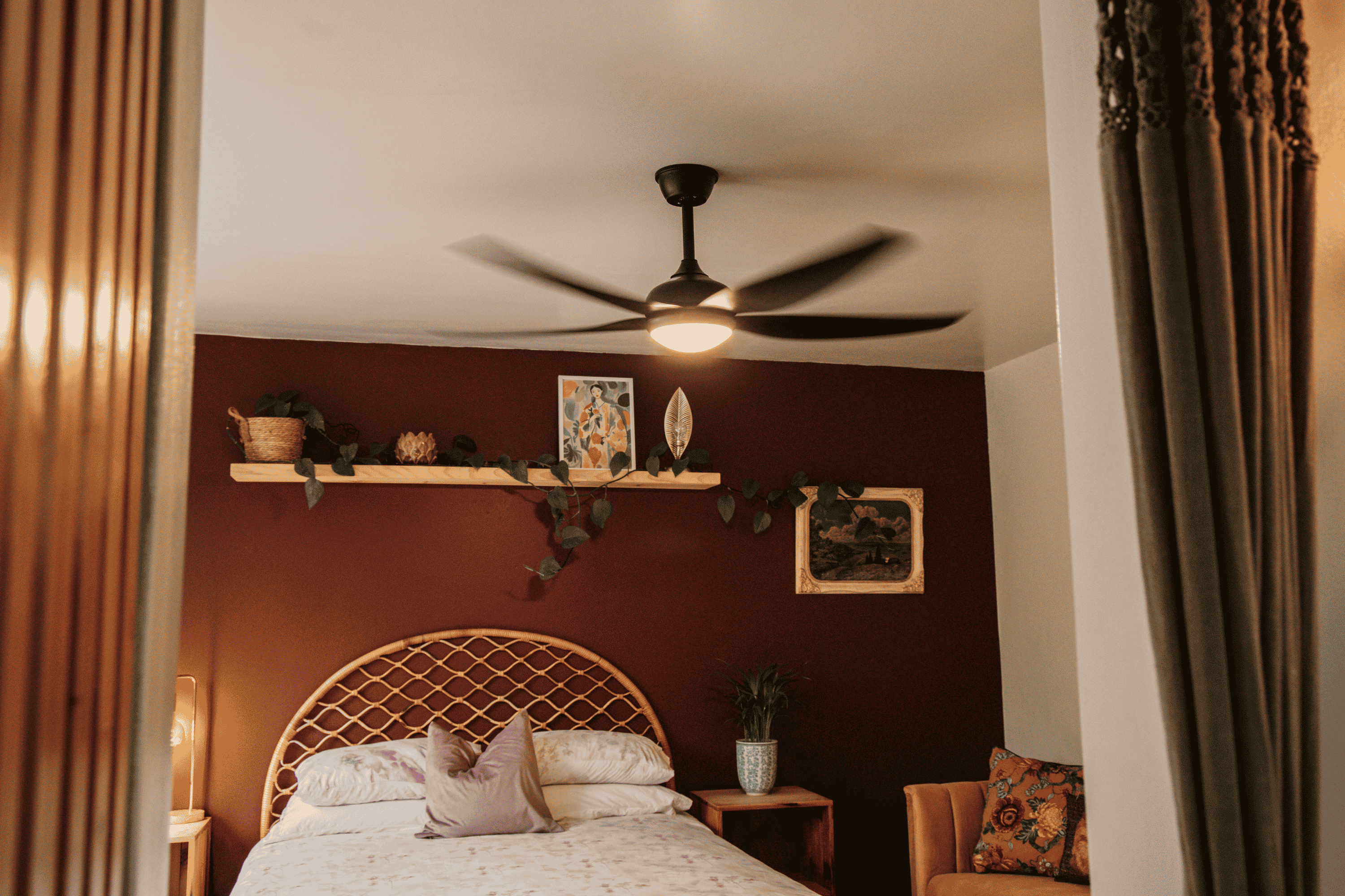 Stellar Lighting 5 Black Blade Ceiling Fan with light blowing full power with AC Motor in a bedroom.