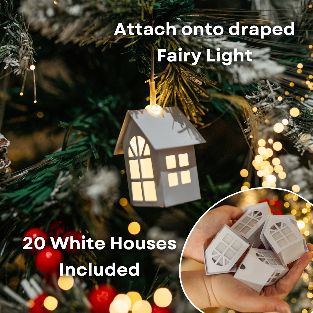 Illuminated mini white house ornament hanging on a Christmas tree branch with inset showing four mini houses held in hand, 20 included
