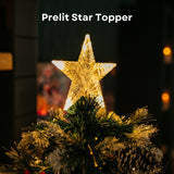 Illuminated star topper glowing warm white atop a prelit Christmas tree with pine cones below
