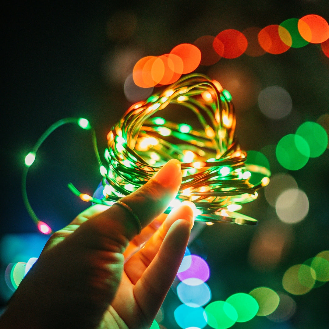 Closeup of 10m colourful LED fairy lights on a green wire