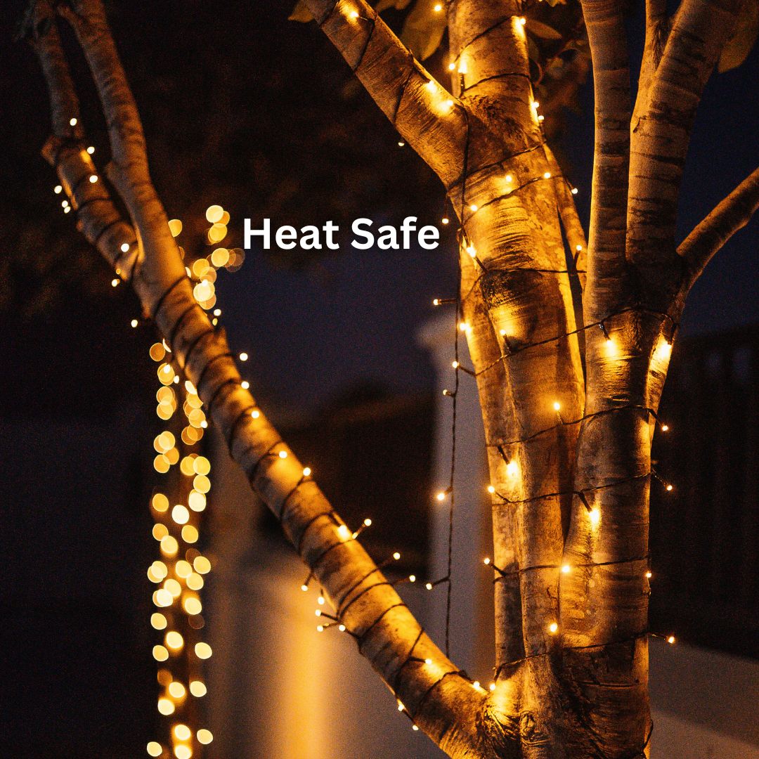 A photo showcasing Solar Fairy Lights and their Heat Safe feature wrapped in a tree. 