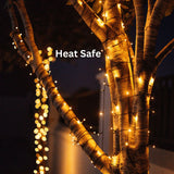 A photo showcasing Solar Fairy Lights and their Heat Safe feature wrapped in a tree. 