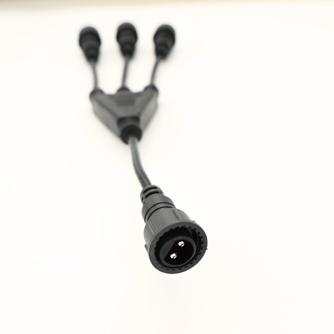 Closeup of the cable connection point linking the 3-way connector to the main string light plug