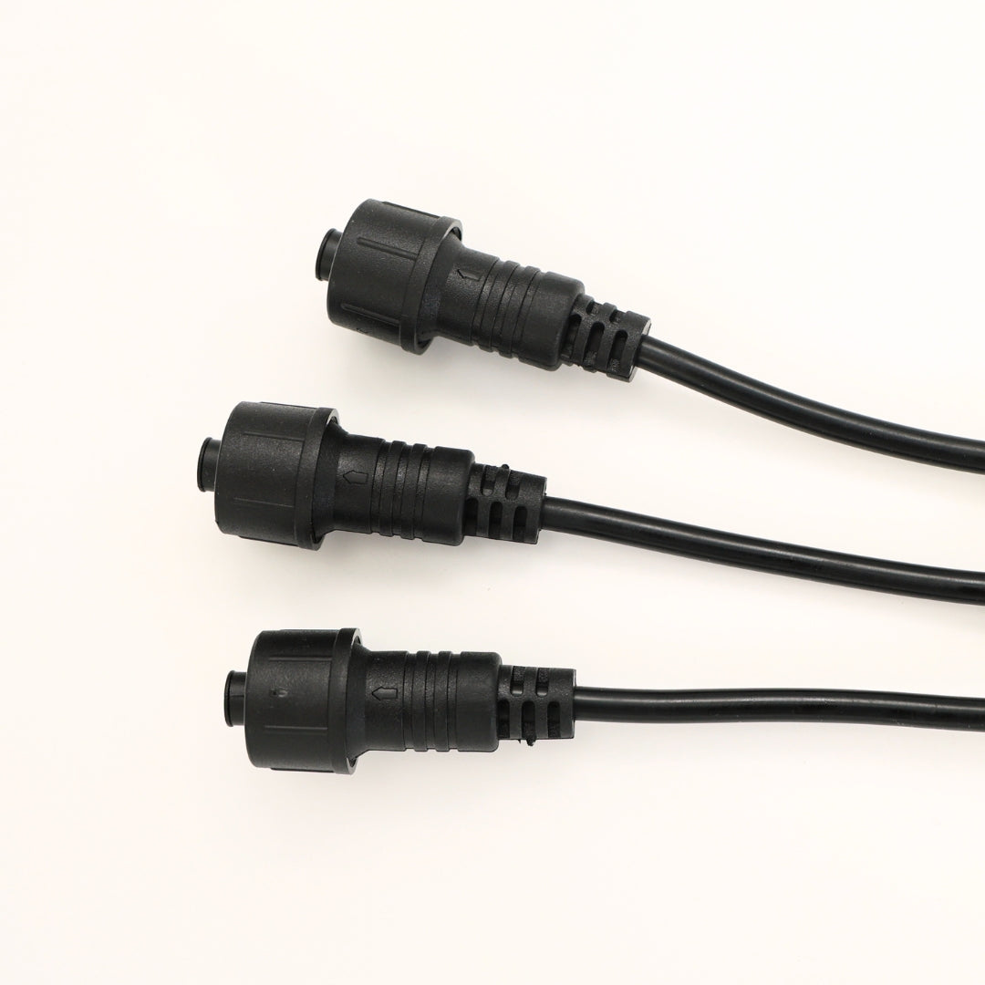 Closeup of the three attachment points on the black 3-way string light connector