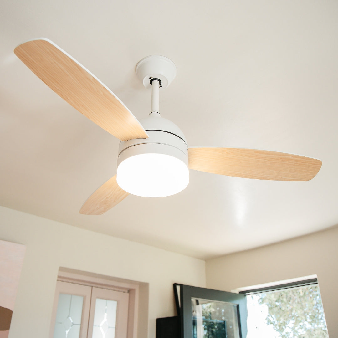 Close-up of 42 inch ceiling fan showing reversible MDF blade wood look finish and motor body from below