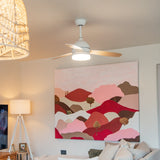 42 inch reversible wood and white blade ceiling fan installed in a modern South African boho lounge with warm white light glowing and three reversible blades
