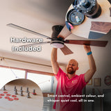 Man in Stellar Lighting shirt installing 52 inch black wood smart LED ceiling fan with hardware included callout and inset showing screws and mounting hardware included in the box