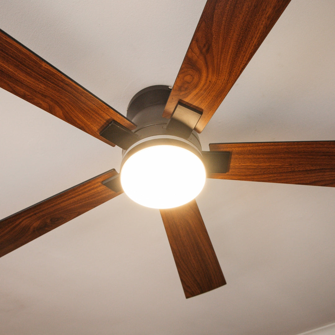 Close-up of 52 inch black wood smart LED ceiling fan matte black motor body and integrated LED light kit with RGB ambient ring detail