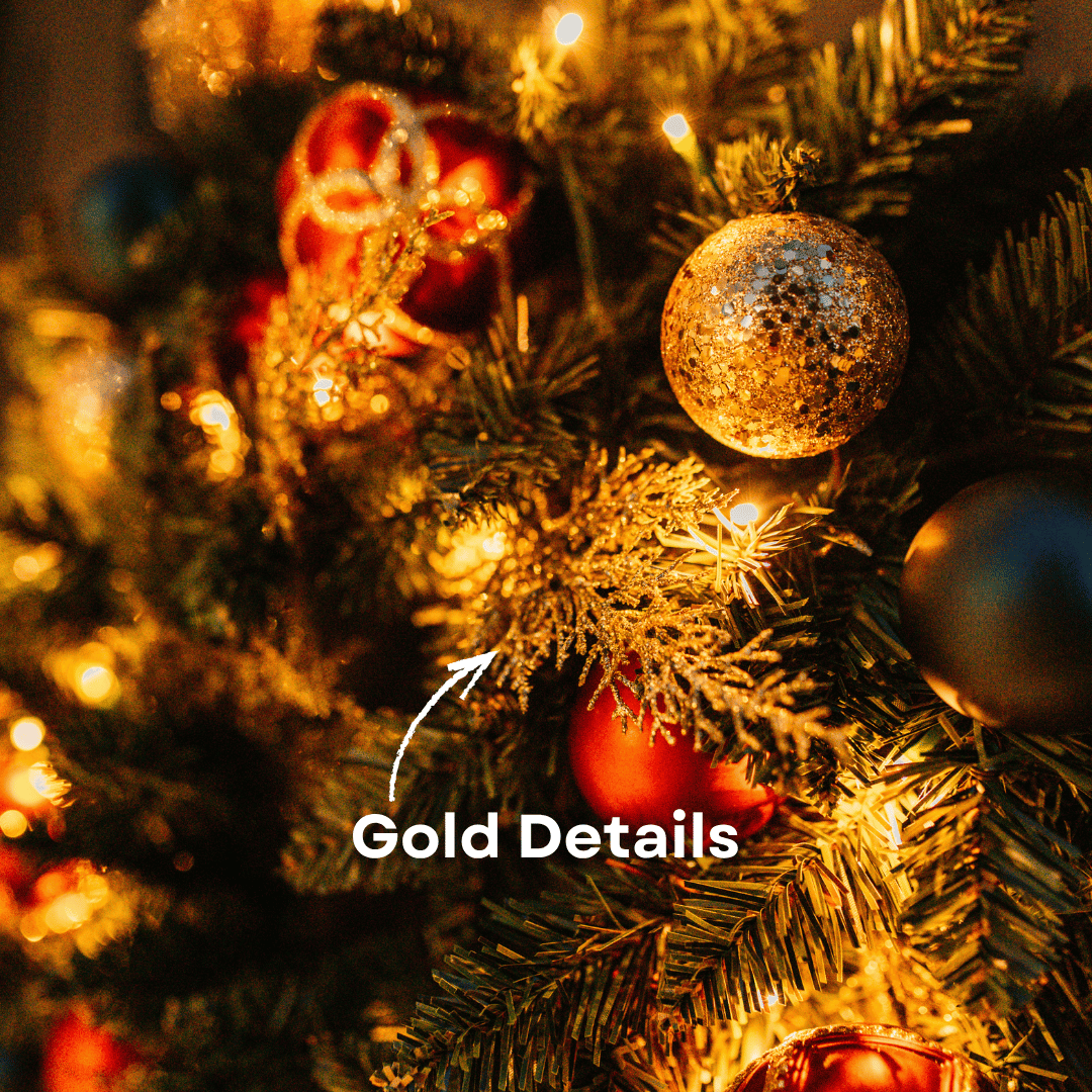 Close-up of gold glitter pine sprigs and ornaments on a Christmas wreath