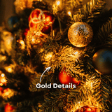 Close-up of gold glitter pine sprigs and ornaments on a Christmas wreath