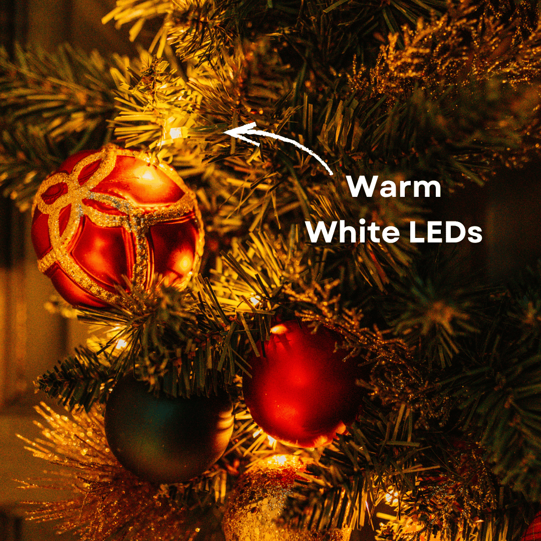 Close-up of a warm white LED light nestled in a Christmas wreath's pine foliage