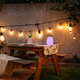 Bluetooth Speaker Lantern with wooden handle creating warm ambient glow on an outdoor table during a South African evening gathering