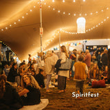 Classic String Lights with 25 warm white G40 globe bulbs strung across Spiritfest creating a warm continuous golden glow at night