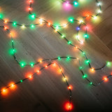String lights with multicolor bulbs on a wooden floor