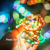 Hand holding colourful LED fairy lights showing cool-touch, heat-safe design