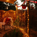 Backyard with curtain fairy lights, outdoor furniture, and decorative elements.