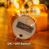 Underside of domed glass flameless LED candle showing 2 AA battery compartment and on/off switch with batteries not included callout
