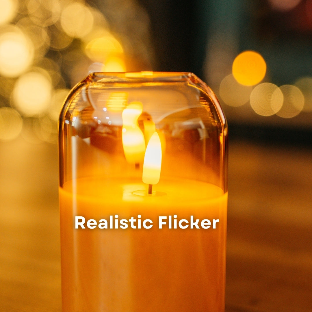 Close-up of warm amber LED realistic flicker inside a domed gold glass flameless candle with bokeh background