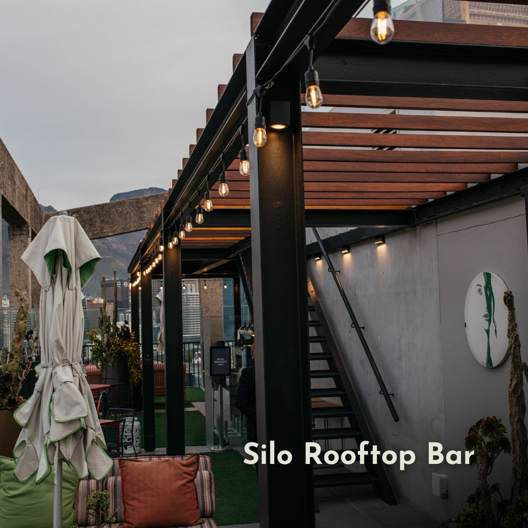 Silo Rooftop Bar with outdoor seating area, string lights overhead and a Table mountain view