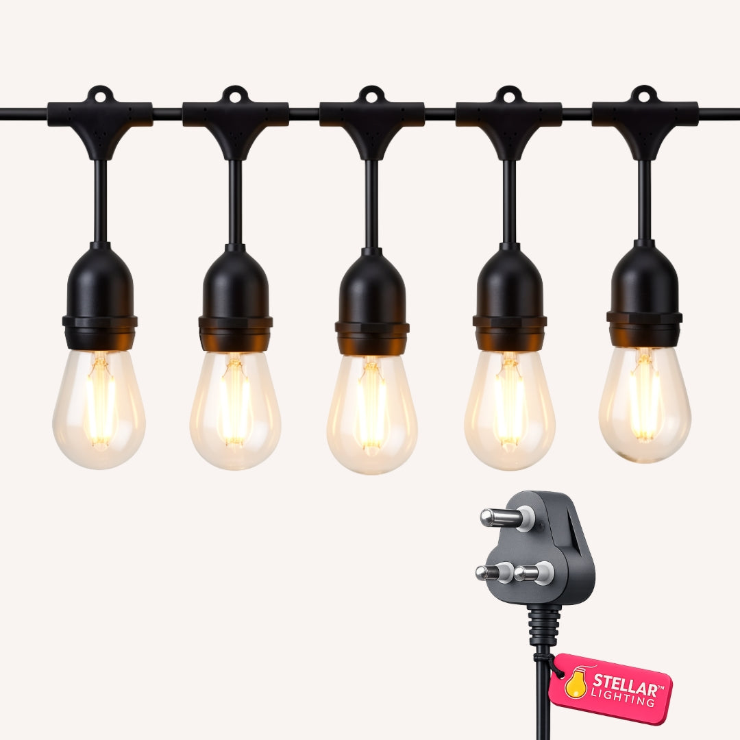 String of drop string lights with warm white bulbs and black holders and a power plug on a white background, branded 'Stellar Lighting'.