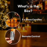Glass Candles with a remote control, set against a blurred festive background.