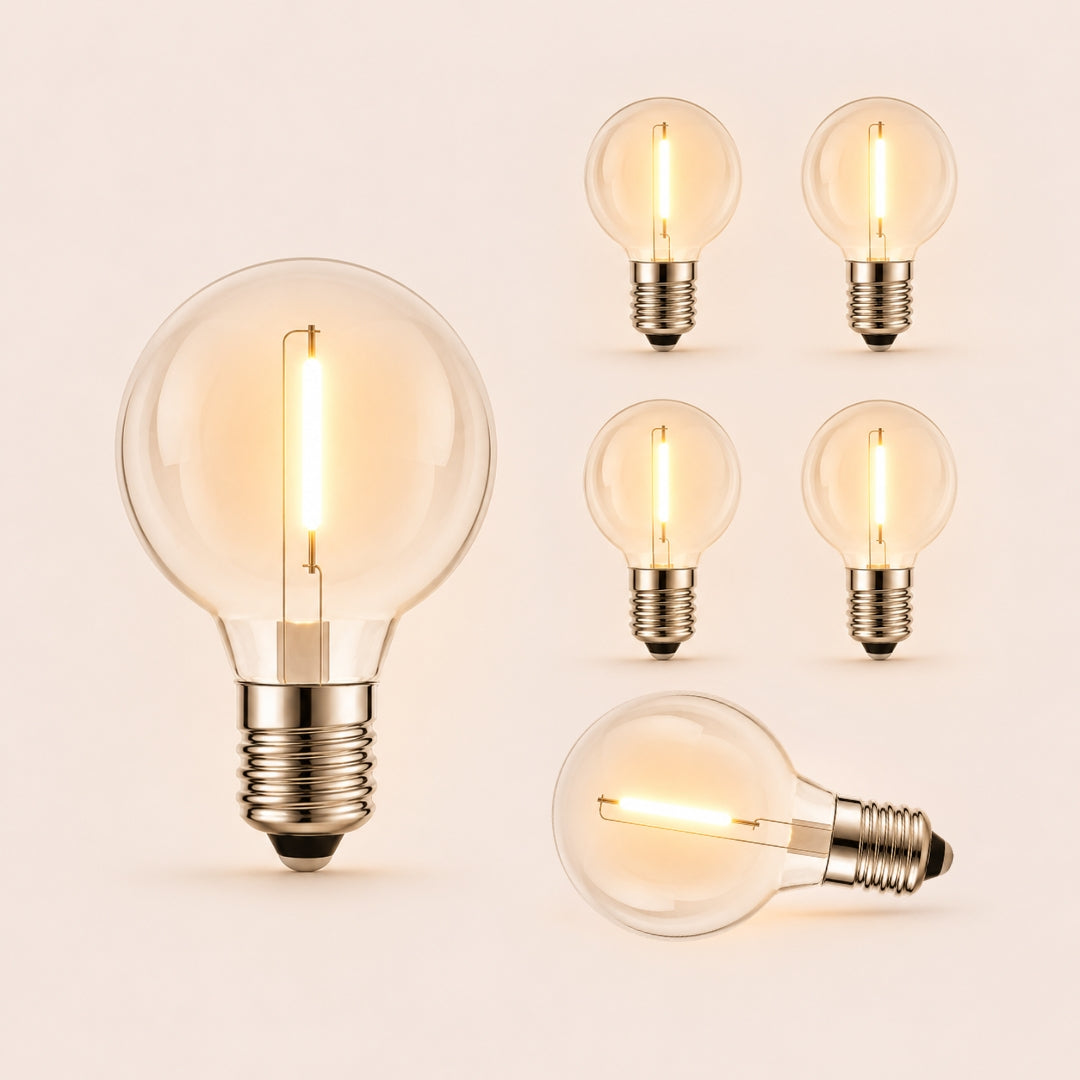 Six G40 globe LED replacement bulbs with E12 fitting and warm white filament glow on a light background
