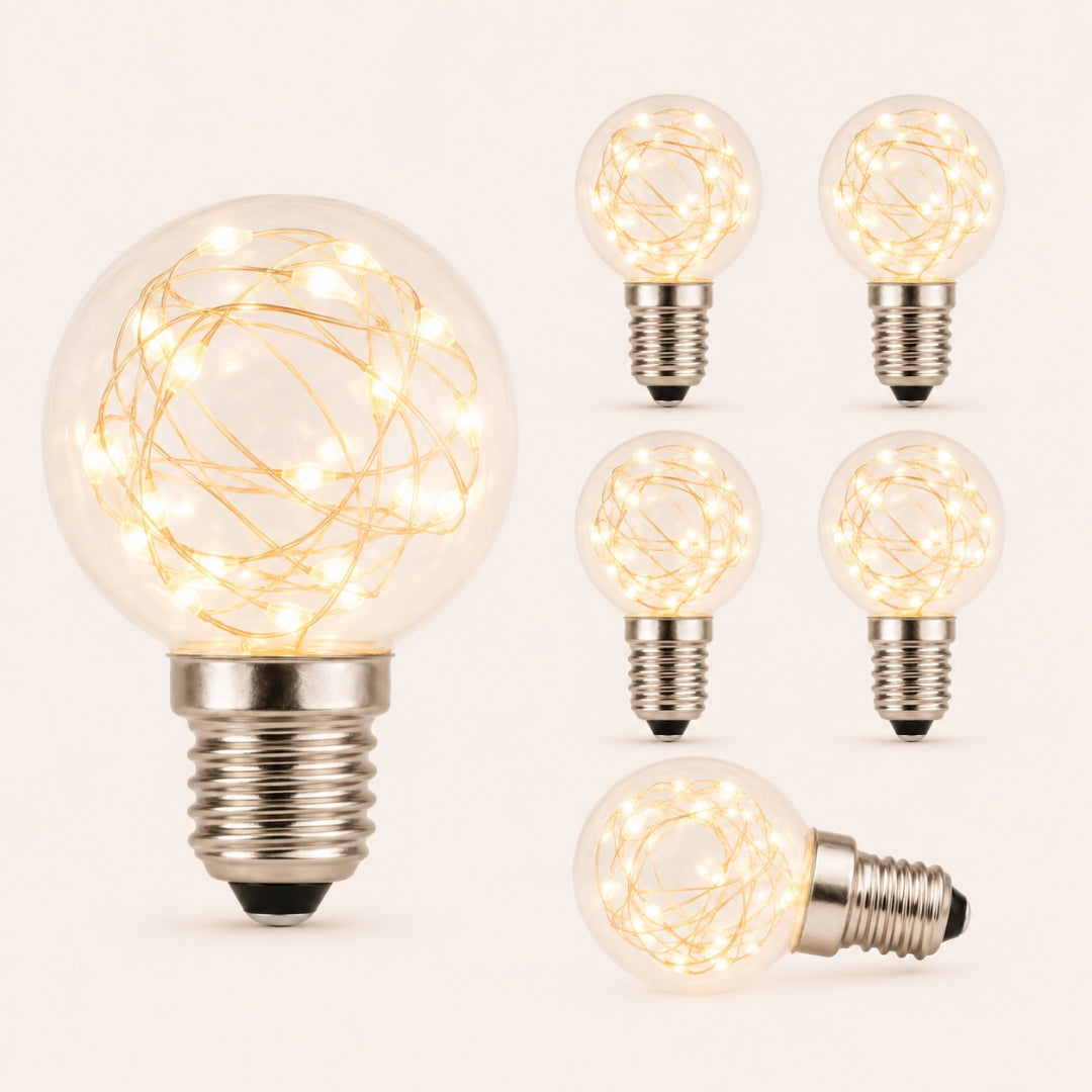 Six G40 wire LED replacement bulbs with copper wire detail and E12 fitting glowing warm white on a light background