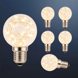 Six G40 wire LED replacement bulbs with copper wire detail and E12 fitting glowing warm white on a dark navy background