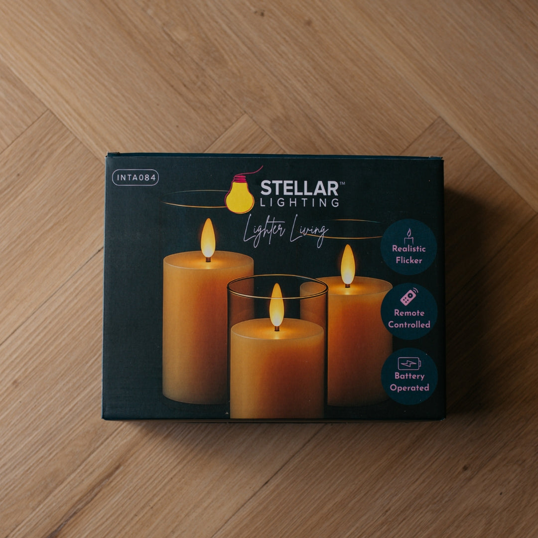 Box of Stellar Lighting battery flameless candle lights on a wooden surface
