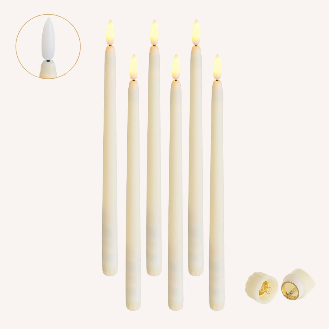 Set of six ivory flameless LED taper candles with warm amber flicker on white background with twist on/off switch close-up inset