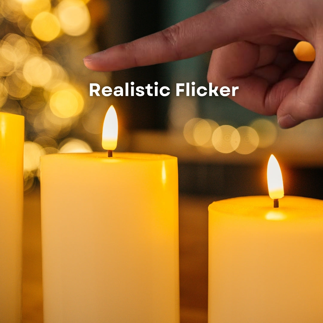 Close-up of warm amber LED realistic flicker on ivory real wax flameless LED pillar candles with hand in frame and bokeh background