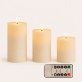 Set of three smooth white real wax flameless LED pillar candles in graduated heights with remote control on white background