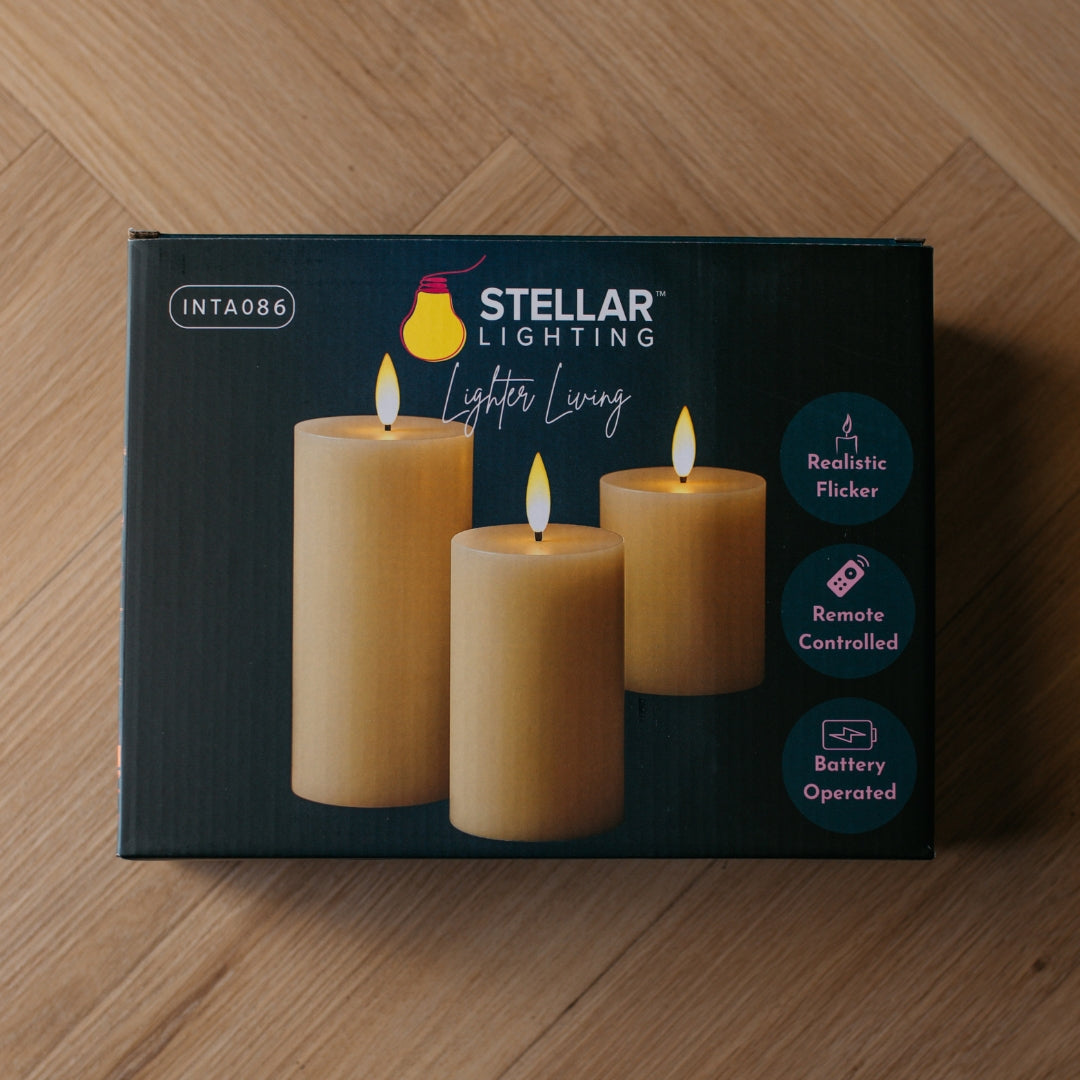 Stellar Lighting product box for ivory pillar flameless LED candles showing realistic flicker, remote controlled, and battery operated features