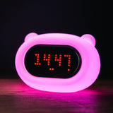 Lightie Clock bear silicone kids night light glowing softly on a bedside table in a children's room