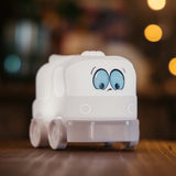 Lightie Truck silicone kids night light glowing softly on a bedside table in a children's room