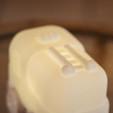Lightie Truck silicone kids night light glowing warm white on a wooden surface showing the fire truck ladder.