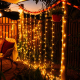 Backyard with curtain fairy lights draped over a wooden fence, creating a warm and cozy atmosphere.