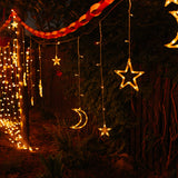 Moon and star curtain fairy lights hanging and glowing with soft warm white light