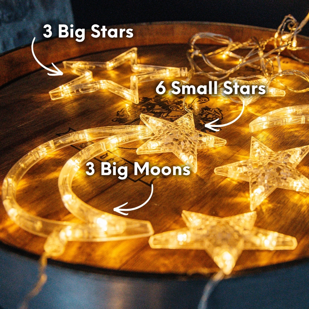 Three shaped LED pendants, large star, crescent moon, and small star, displayed on a wooden barrel