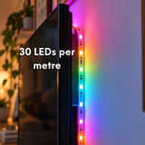 Close-up of RGBIC LED strip light behind a TV showing 30 LEDs per metre density