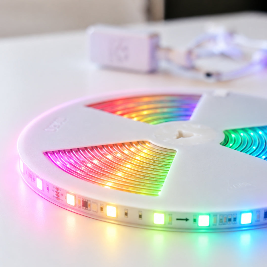 Close-up of RGBIC LED strip light reel glowing in rainbow colours