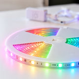 Close-up of RGBIC LED strip light reel glowing in rainbow colours