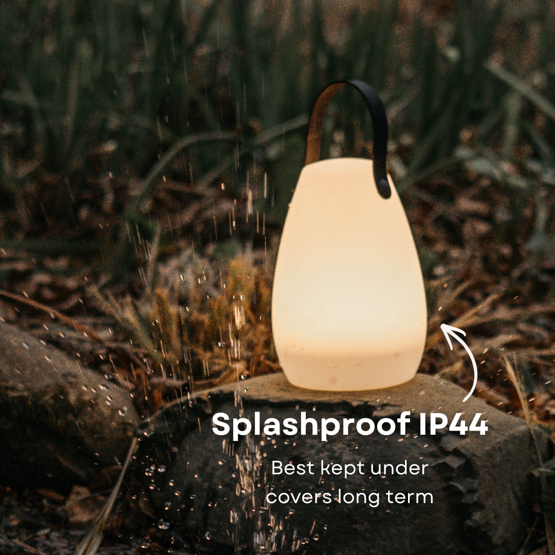 Rechargeable RGB camping lantern showing IP44 splash resistant rating with water splash