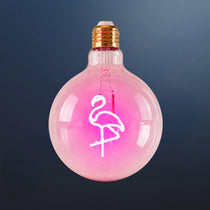 Single G125 globe LED bulb with pink flamingo filament detail and clear glass on a dark navy background