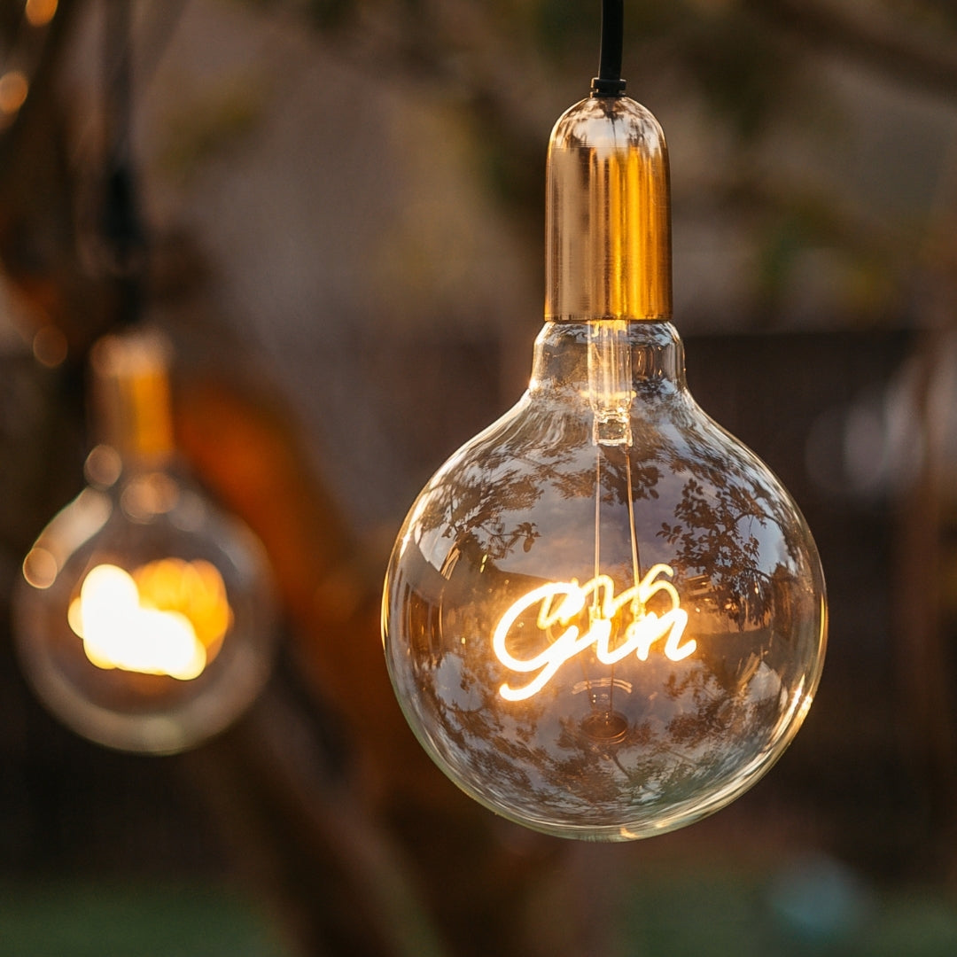 G125 globe LED bulb with warm white GIN filament glowing softly in an interior pendant fitting