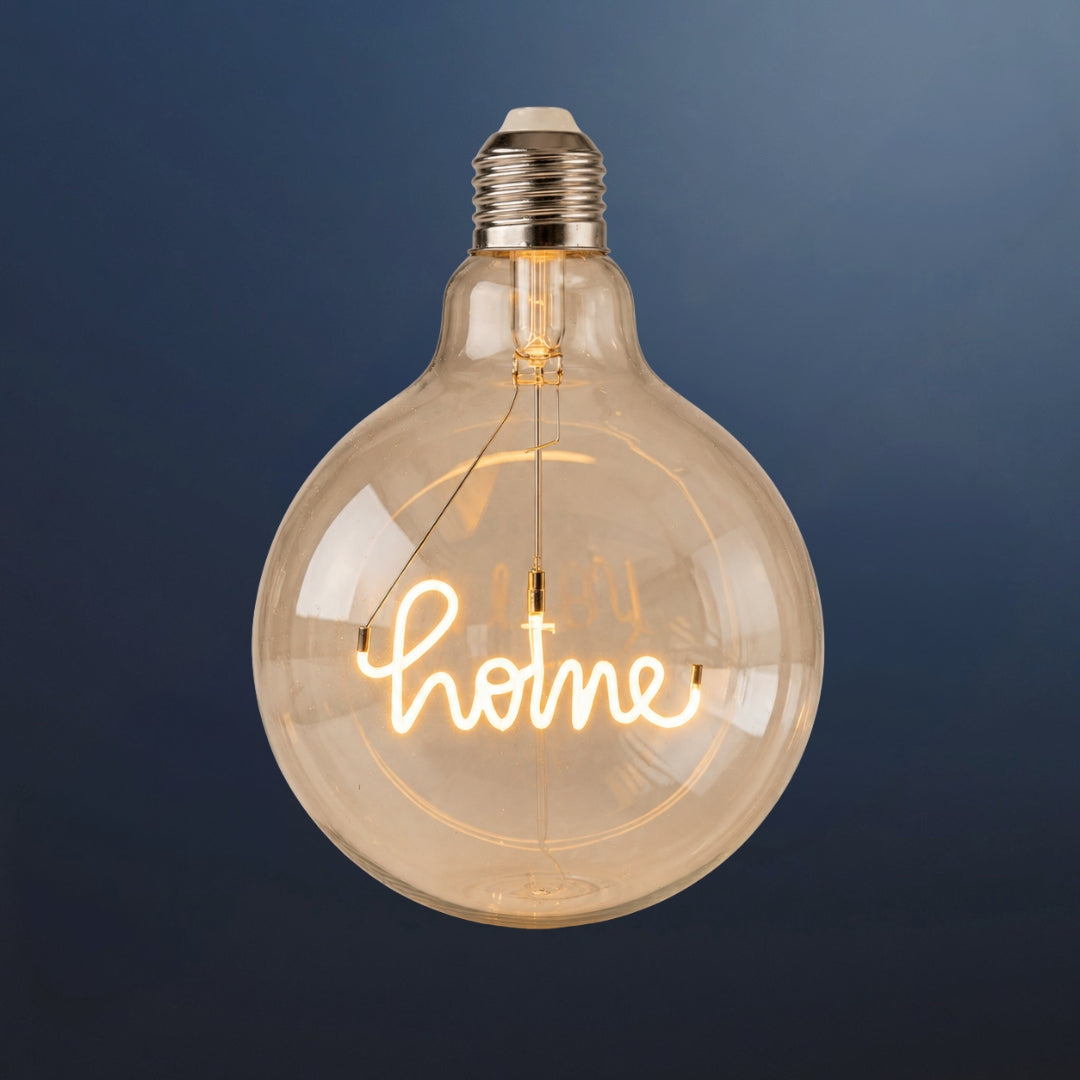 Single G125 globe LED bulb with HOME filament detail and clear glass on a dark navy background