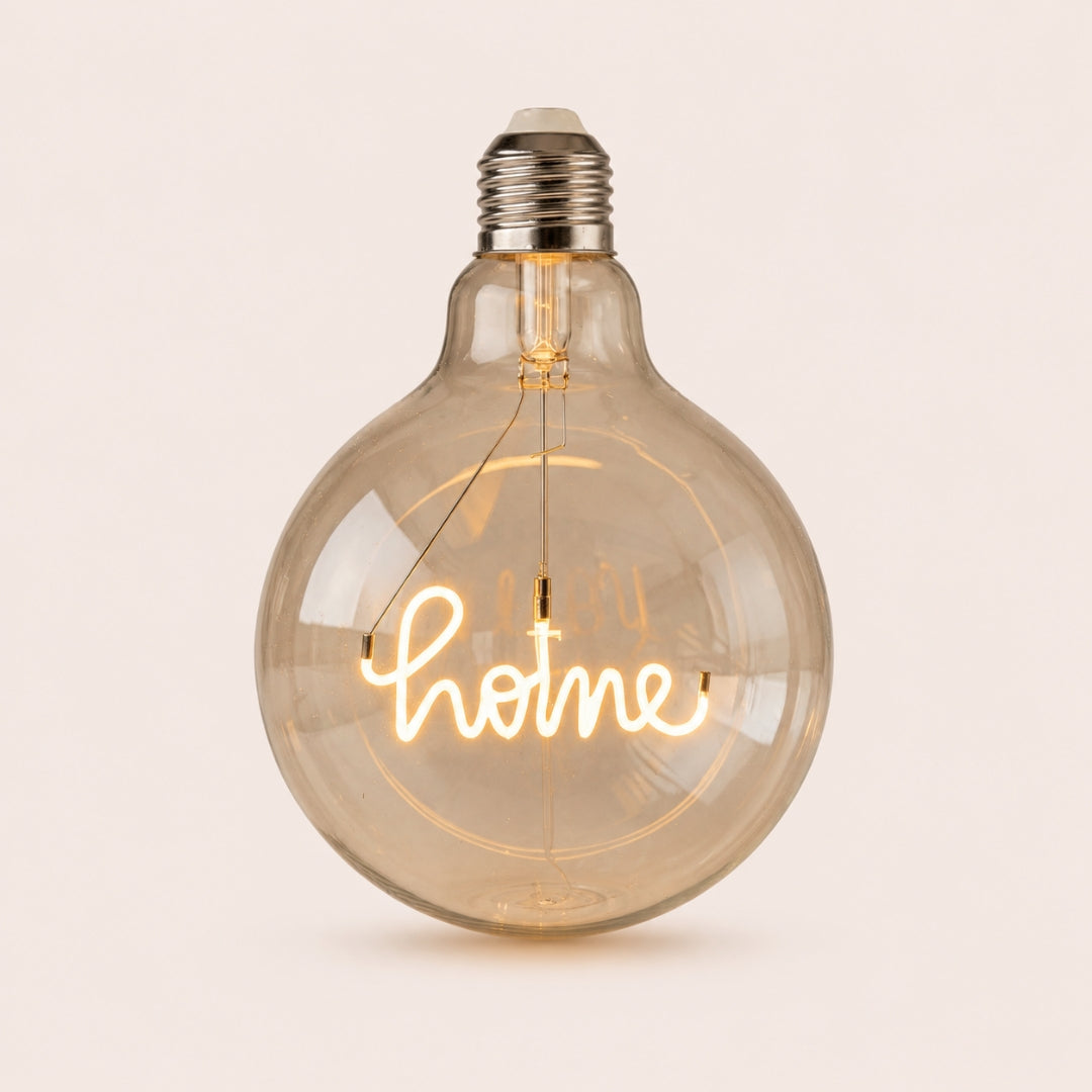 Single G125 globe LED bulb with HOME filament detail and clear glass on a light background