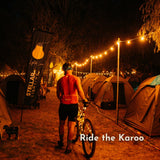 White Festoon String Lights with warm white G45 globe bulbs strung across Ride the Karoo at night with a bicycle and camping