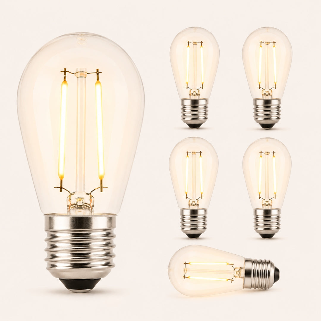 Six S14 vintage LED festoon bulbs with E27 fitting and warm amber filament glow on a light background