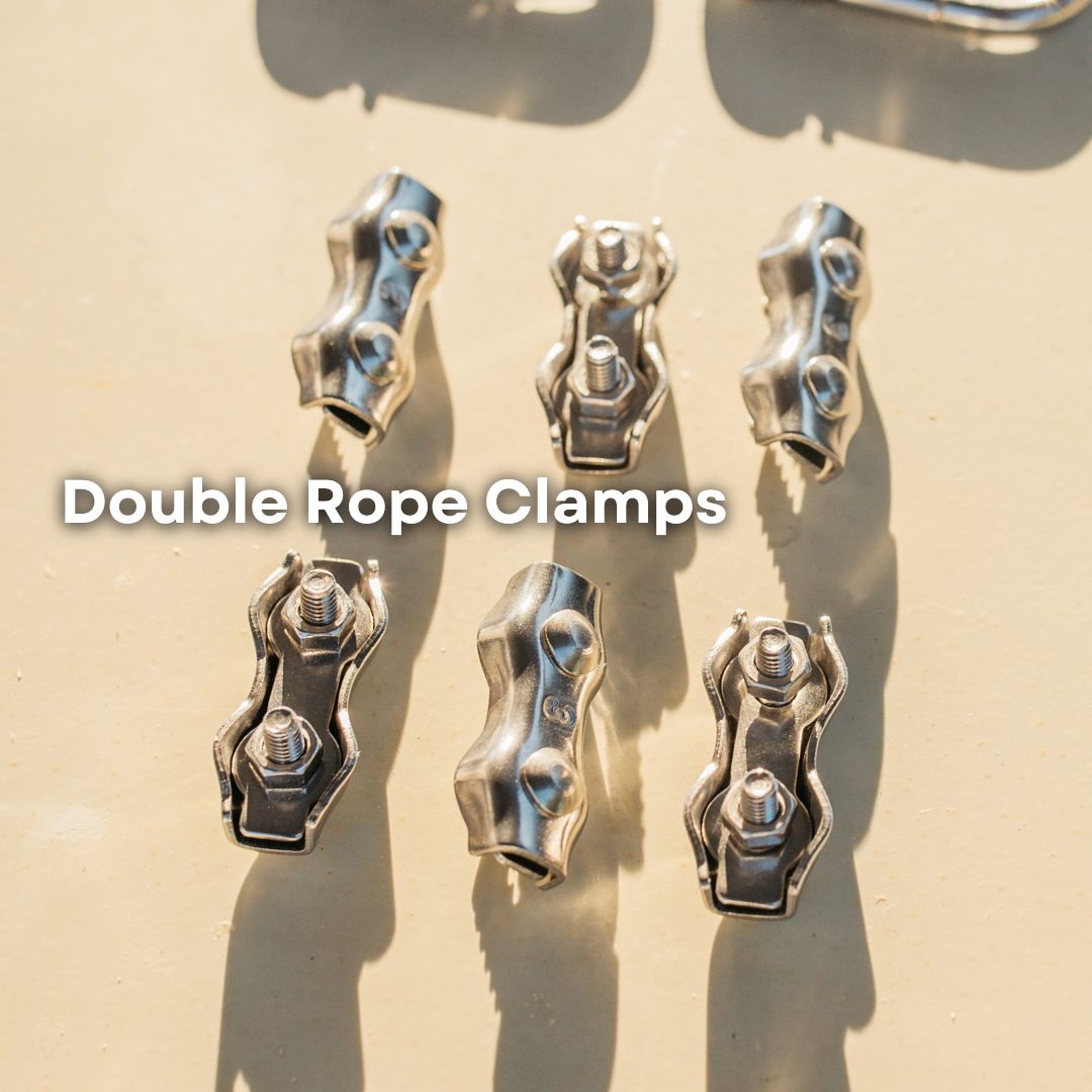 Six metallic double rope clamps arranged on a light beige surface with strong sunlight and shadows. White text overlay reads 'Double Rope Clamps'.